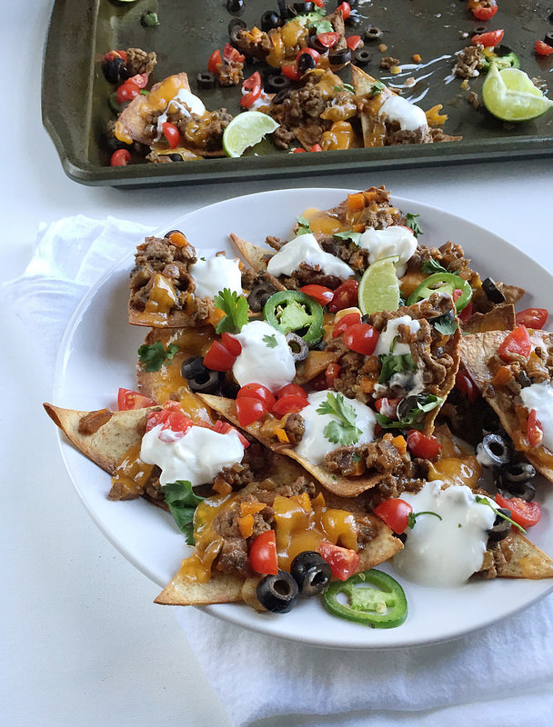 Loaded Healthy Beef Nachos! A homemade healthy beef nachos recipe with baked tortilla chips and all the fixins! Here's a hearty portion of your favorite appetizer for only 374 calories!