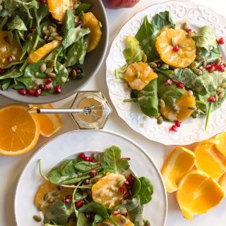 Baby Kale Salad with Orange, Pomegranate, and Maple Tahini Dressing - This gorgeous mix of fall fruits and veggies packs a powerful nutritious punch!
