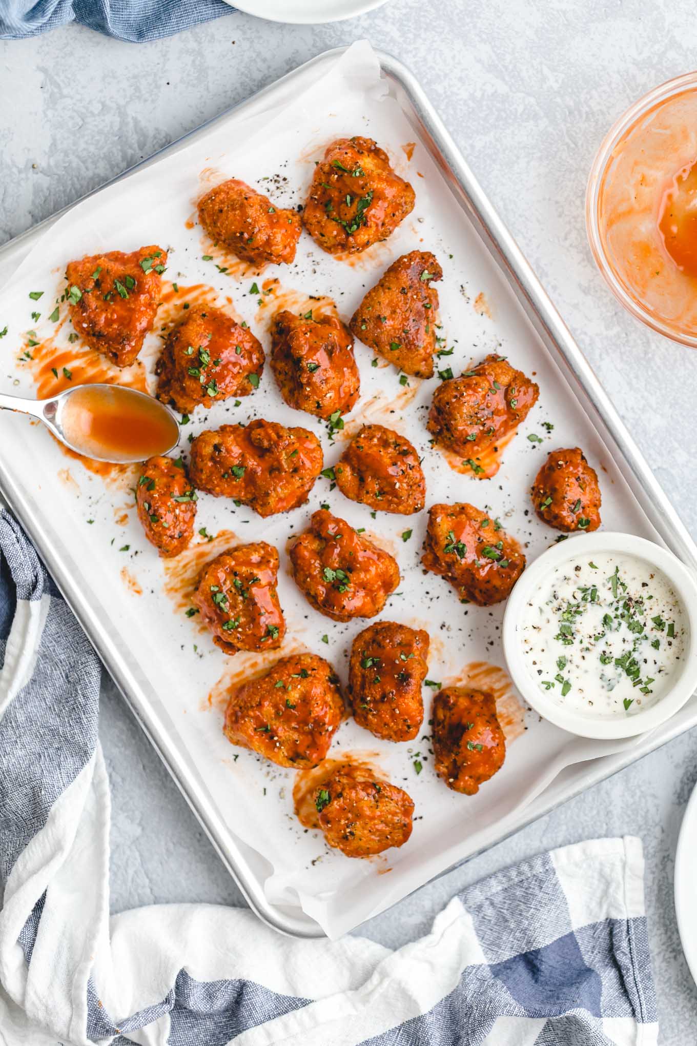 Healthier Baked Buffalo Chicken Nuggets for 418 calories or 6 WW points! This easy recipe is lighter comfort food, with crispy breading, spicy sauce, and cool, creamy blue cheese dressing