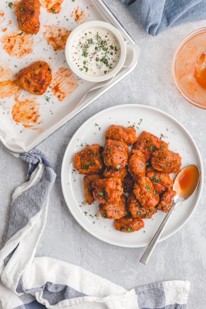 Healthier Baked Buffalo Chicken Nuggets for 418 calories or 6 WW points! This easy recipe is lighter comfort food, with crispy breading, spicy sauce, and cool, creamy blue cheese dressing