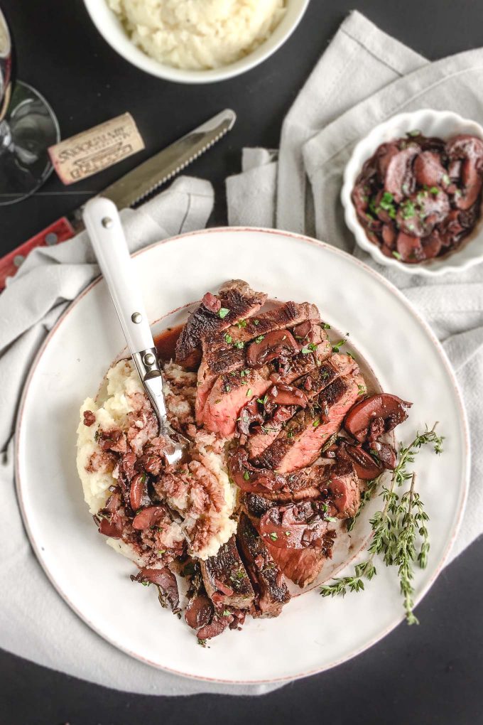 Beef with Red Wine Mushroom Sauce - an easy to prepare beef recipe with restaurant quality appeal and flavor! Just sear tenderloin steaks and saute a thyme-infused mushroom sauce using a dry red wine like cabernet sauvignon