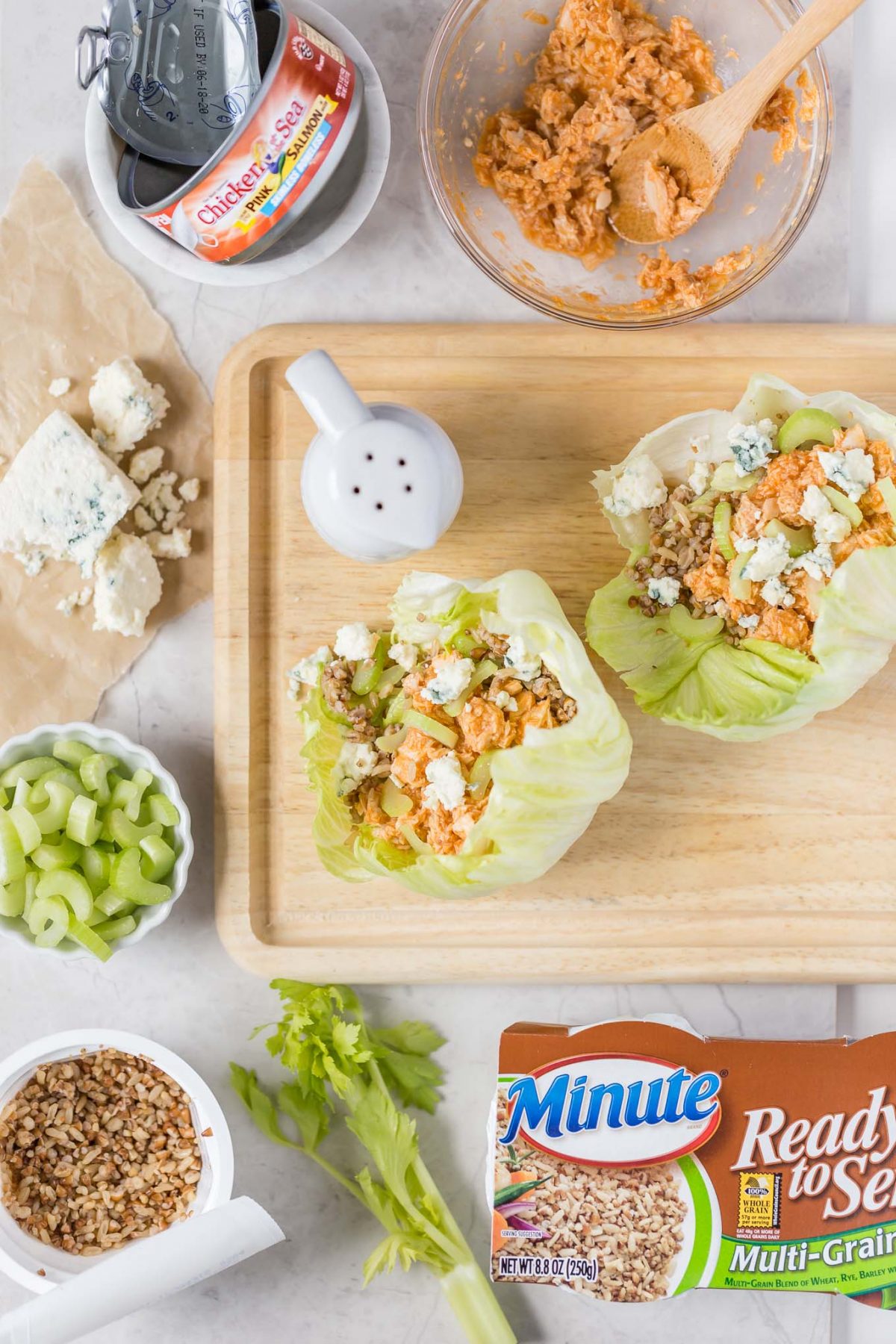 Buffalo Salmon Lettuce Wraps Recipe-A delicious mix of buffalo salmon, crispy celery, multigrain rice, and cool blue cheese inside lettuce wraps! Protein- and fiber-packed, with only 237 cals!