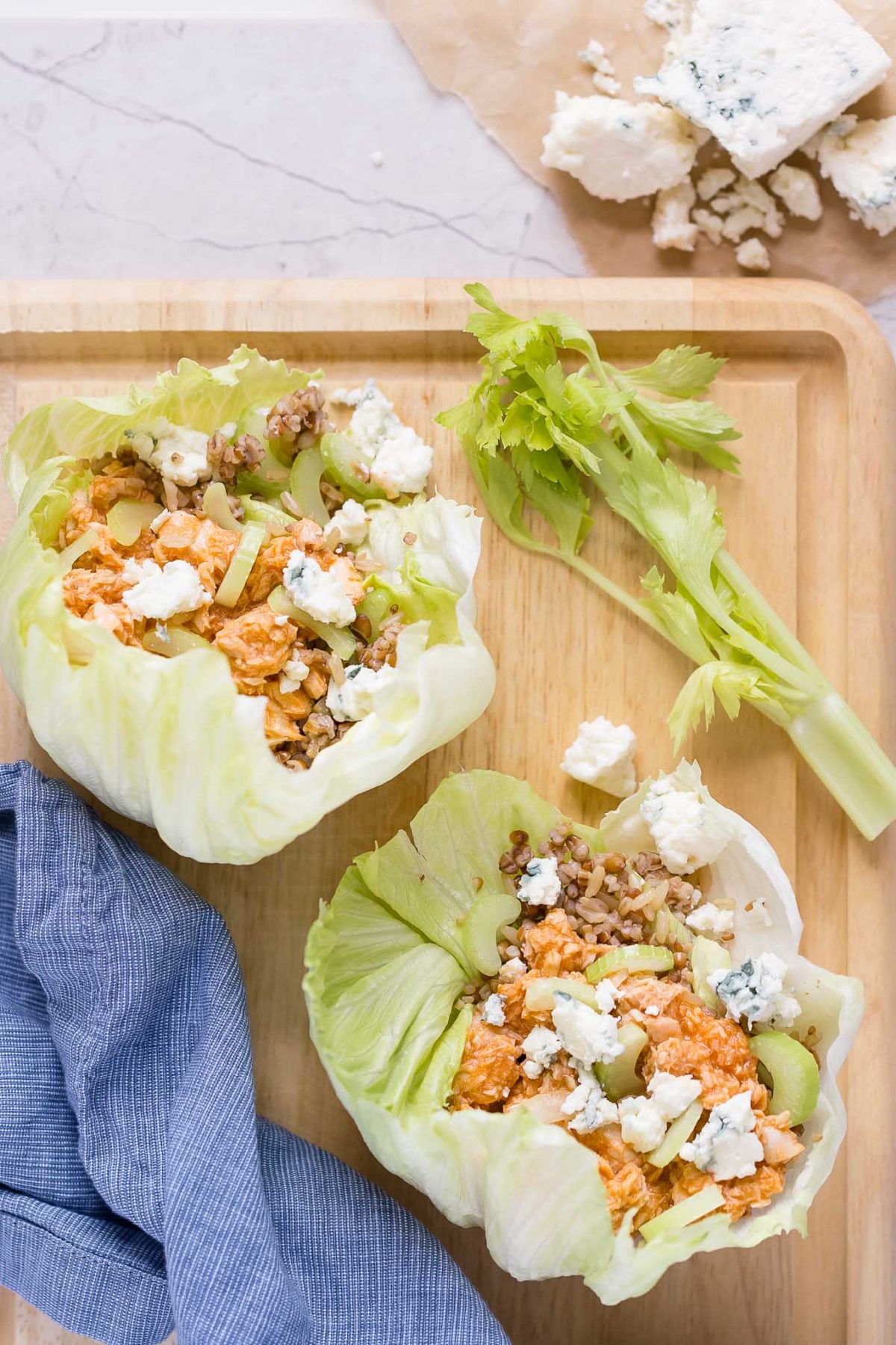 Buffalo Salmon Lettuce Wraps Recipe-A delicious mix of buffalo salmon, crispy celery, multigrain rice, and cool blue cheese inside lettuce wraps! Protein- and fiber-packed, with only 237 cals!