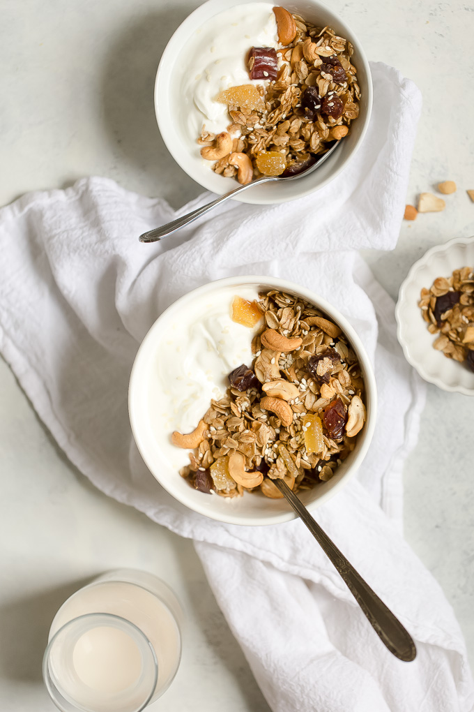 Cashew Ginger Granola with Medjool Dates and Sesame Seeds Recipe - a healthy whole grain granola recipe with cashews, medjool dates, crystallized ginger, sesame seeds, and the warm flavors of cinnamon, allspice and ginger. 295 calories per filling, delicious  serving