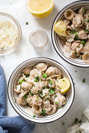 Creamy Orecchiette with Goat Cheese and Tuna Recipe - Move over tuna noodle casserole! This comfort food pasta dish is made with whole wheat orecchiette, herbed goat cheese, canned tuna, and sweet peas!