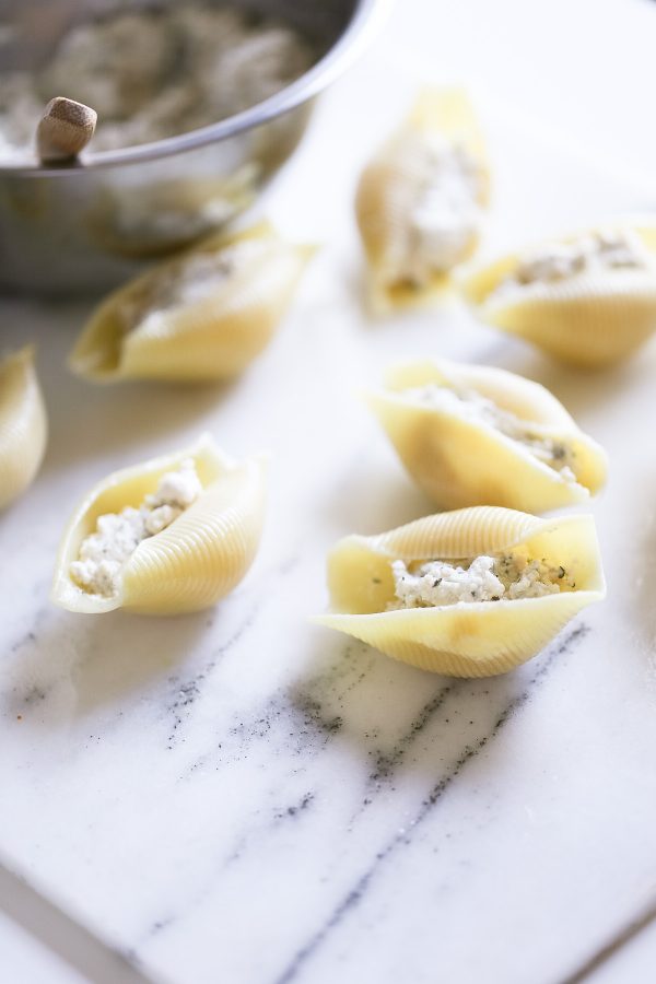 Easy (and Light!) Stuffed Shells Recipe with a secret ingredient to make them low calorie and high protein, too! These are make ahead and freezer friendly!