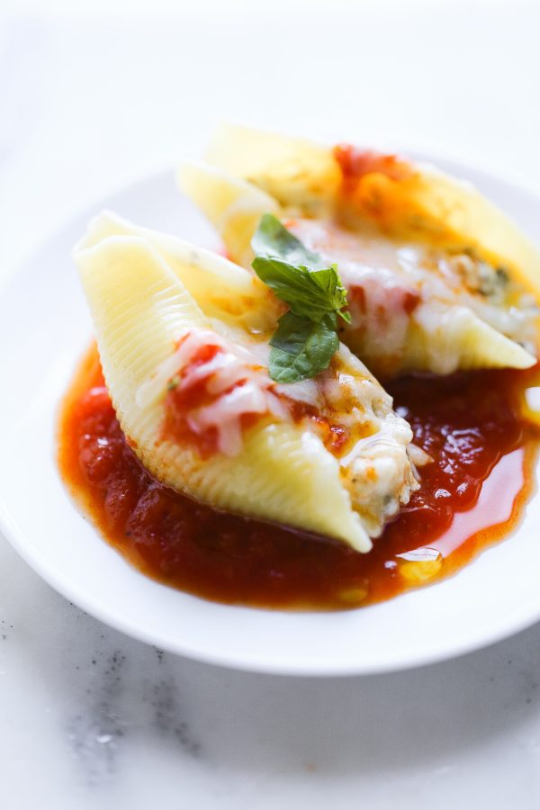 Easy (and Light!) Stuffed Shells Recipe with a secret ingredient to make them low calorie and high protein, too! These are make ahead and freezer friendly!