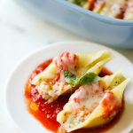 Easy (and Light!) Stuffed Shells Recipe with a secret ingredient to make them low calorie and high protein, too! These are make ahead and freezer friendly!