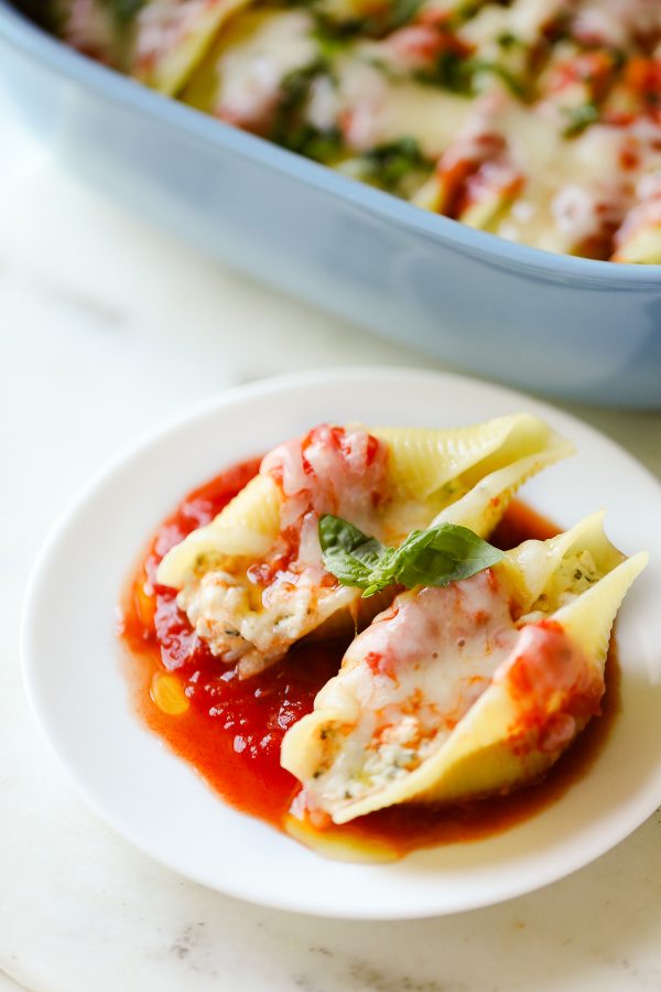 Easy (and Light!) Stuffed Shells Recipe with a secret ingredient to make them low calorie and high protein, too! These are make ahead and freezer friendly!