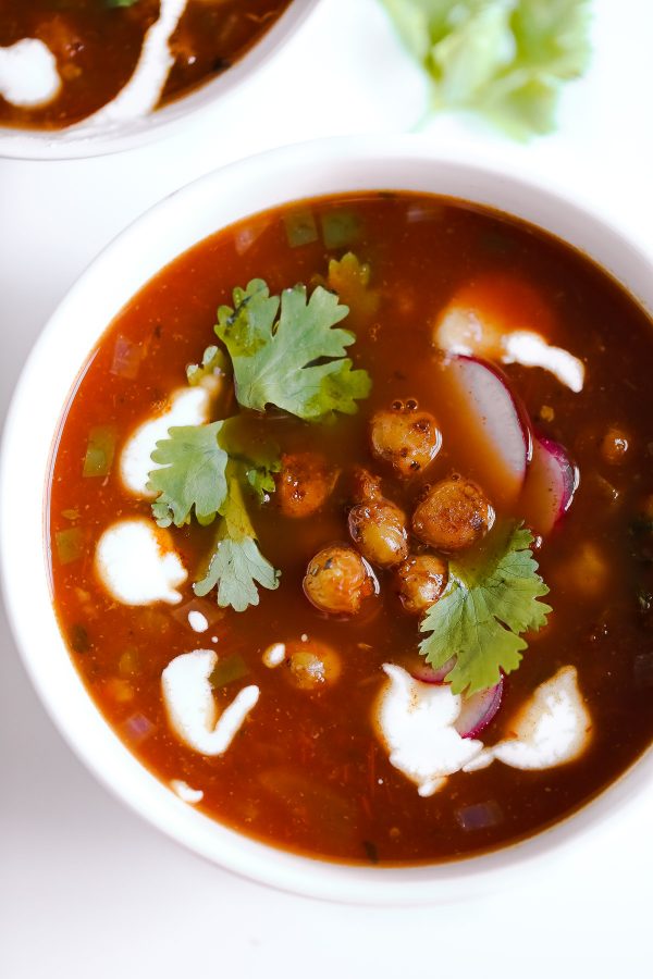 Vegetarian Tortilla Soup Recipe with Chili Roasted Chickpeas! A flavor powerhouse! This vegetarian soup recipe is rich with Mexican flavors like cumin and chili powder, and mildly spicy from sautéed jalapeño pepper. Top the soup with these garlic, oregano, and chili roasted chickpeas to make the soup lighter than traditional versions that have fried tortilla strips, while also boosting the protein and fiber! 