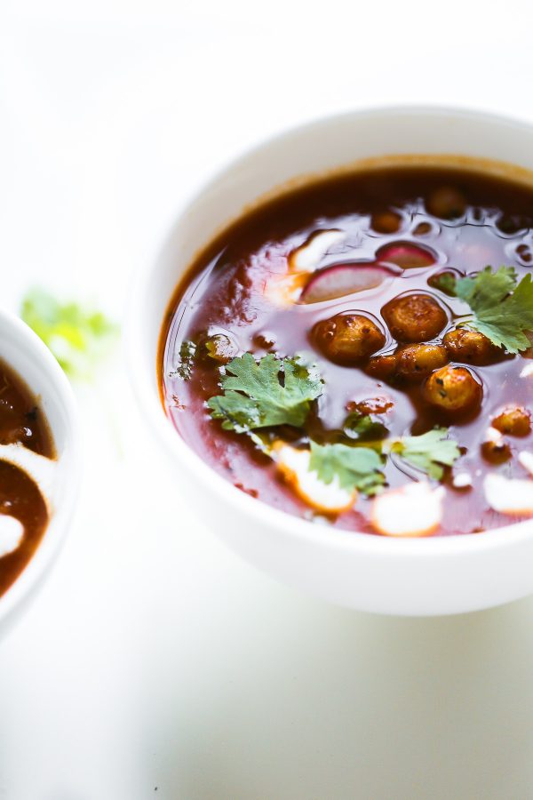 Vegetarian Tortilla Soup Recipe with Chili Roasted Chickpeas! A flavor powerhouse! This vegetarian soup recipe is rich with Mexican flavors like cumin and chili powder, and mildly spicy from sautéed jalapeño pepper. Top the soup with these garlic, oregano, and chili roasted chickpeas to make the soup lighter than traditional versions that have fried tortilla strips, while also boosting the protein and fiber! 