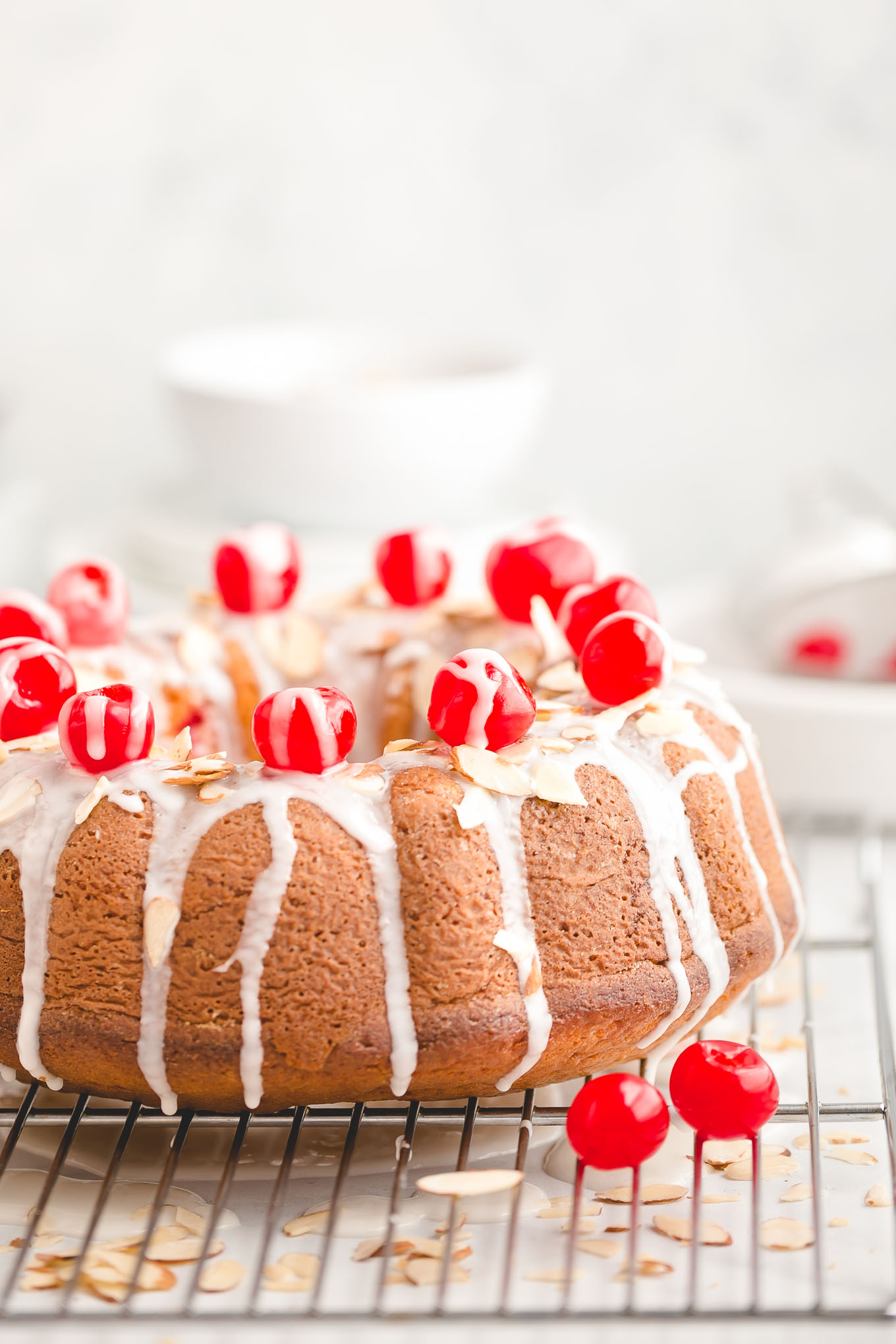 Easy Cherry Almond Bundt Cake - Made with yellow cake mix, instant vanilla pudding mix, almond extract, a jar of maraschino cherries, and sliced almonds, this easy bundt cake recipe is full of irresistible cherry almond flavor and effortlessly soft and tender. 
