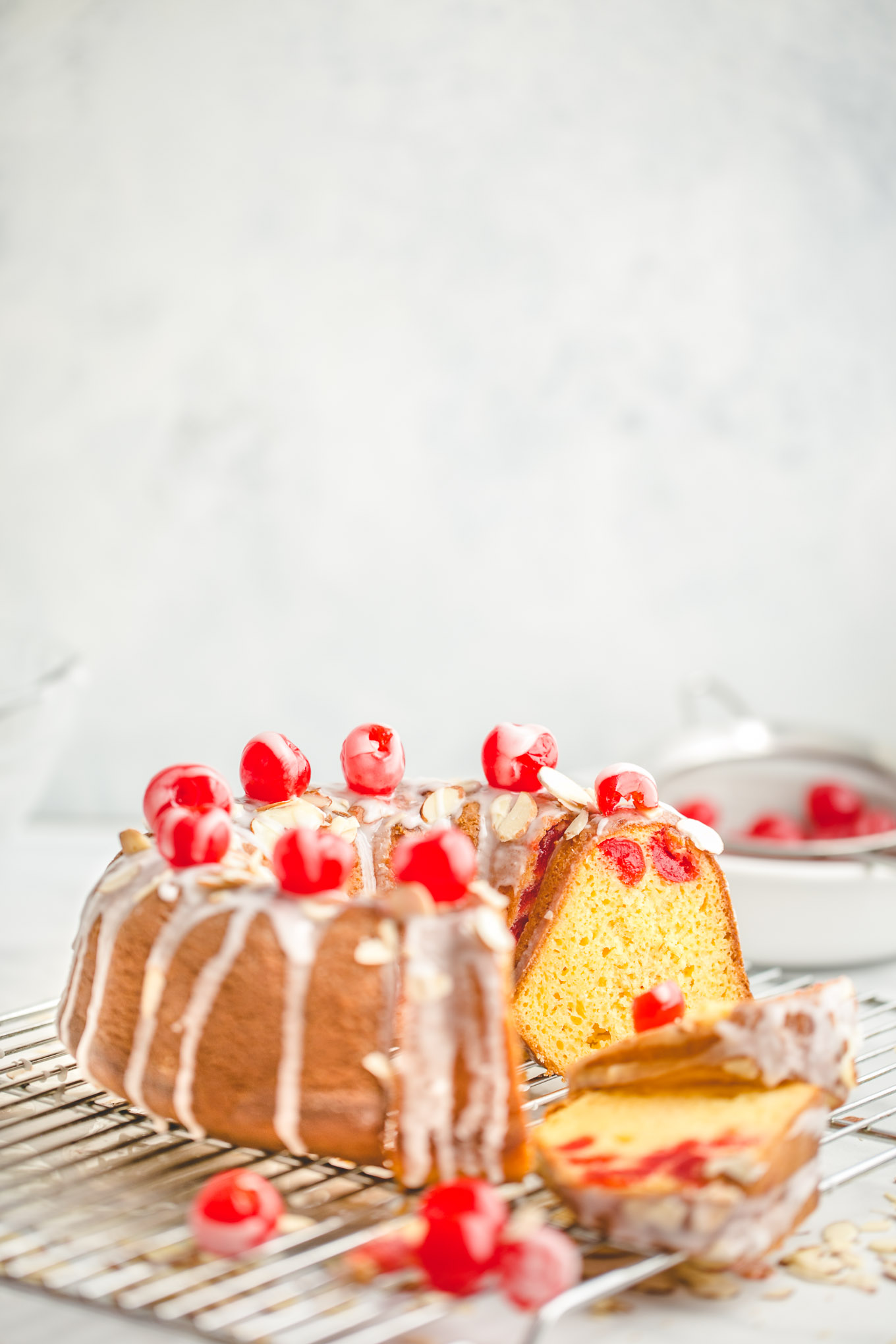 Easy Cherry Almond Bundt Cake - Made with yellow cake mix, instant vanilla pudding mix, almond extract, a jar of maraschino cherries, and sliced almonds, this easy bundt cake recipe is full of irresistible cherry almond flavor and effortlessly soft and tender. 