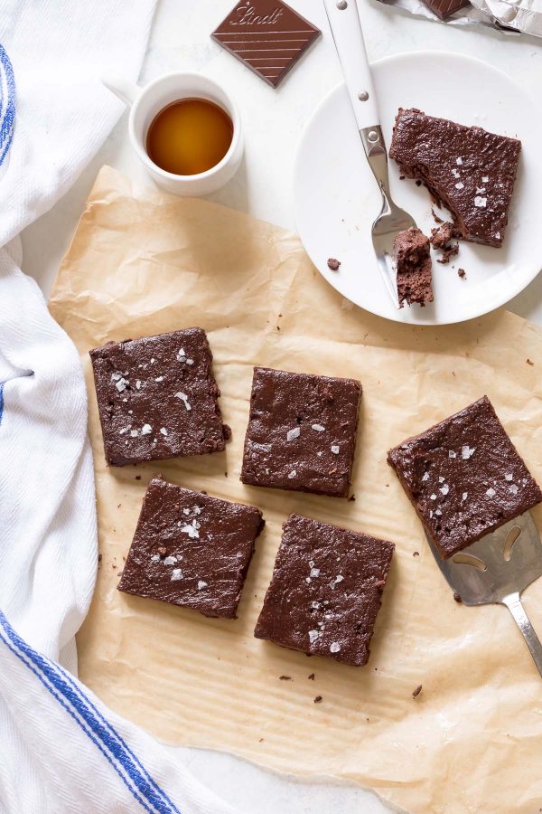 Fudgy 100 Calorie Healthy Brownies - For 100 calories, enjoy fudgy, healthy brownies rich with dark chocolate flavor. Recipe is made with white whole wheat flour, maple syrup, and greek yogurt