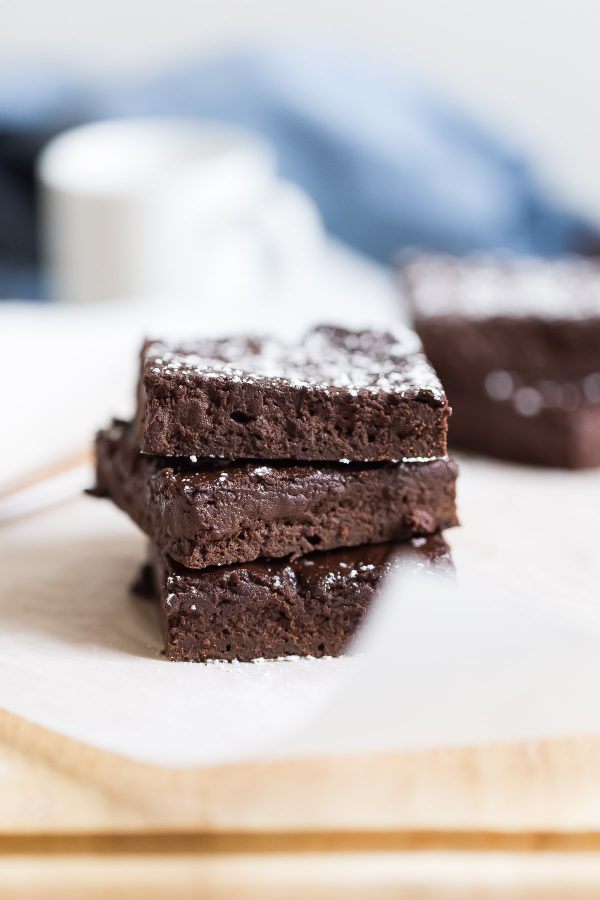 Fudgy 100 Calorie Healthy Brownies - For 100 calories, enjoy fudgy, healthy brownies rich with dark chocolate flavor. Recipe is made with white whole wheat flour, maple syrup, and greek yogurt