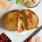 Grilled Cheese with Havarti Sun Dried Tomatoes Prosciutto and Artichokes! This Italian-style grilled cheese sandwich recipe is PACKED with flavor and delicious melty Arla Havarti cheese
