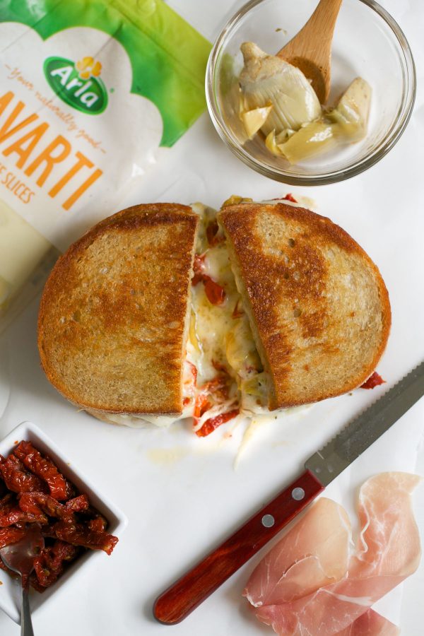 Grilled Cheese with Havarti Sun Dried Tomatoes Prosciutto and Artichokes! This Italian-style grilled cheese sandwich recipe is PACKED with flavor and delicious melty Arla Havarti cheese