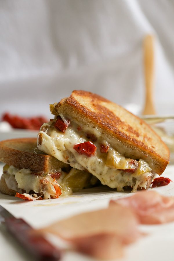 Grilled Cheese with Havarti Sun Dried Tomatoes Prosciutto and Artichokes! This Italian-style grilled cheese sandwich recipe is PACKED with flavor and delicious melty Arla Havarti cheese