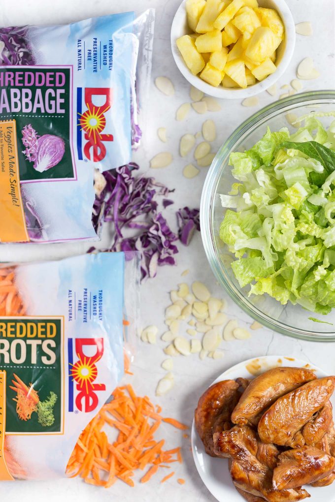 Hawaiian Salad with Pineapple Chicken - This healthy, tropical salad has ginger-soy marinated chicken, pineapple, romaine lettuce, red cabbage, carrots, almonds, and a soy sauce and sesame vinaigrette!