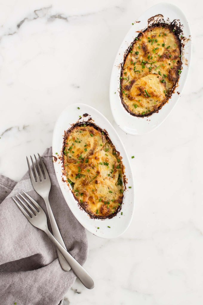 Individual Scalloped Potatoes Recipe - Make creamy, cheesy scalloped potatoes in individual ramekins! This is a lightened up side dish with built-in portion control.
