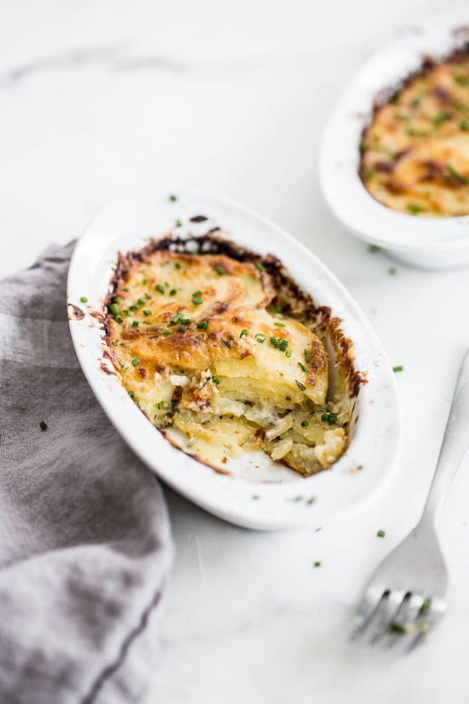 Individual Scalloped Potatoes Recipe - Make creamy, cheesy scalloped potatoes in individual ramekins! This is a lightened up side dish with built-in portion control.
