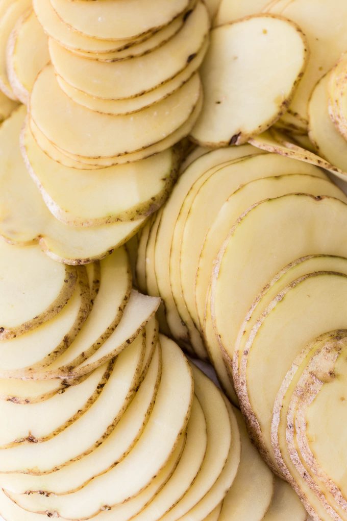 Individual Scalloped Potatoes Recipe - Make creamy, cheesy scalloped potatoes in individual ramekins! This is a lightened up side dish with built-in portion control.