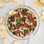 Layered Pepperoni Pizza Dip Recipe - a cheesy dip with artichokes, black olives, cream cheese, mozzarella, and basil that tastes just like a pepperoni pizza! The most delicious light appetizer!