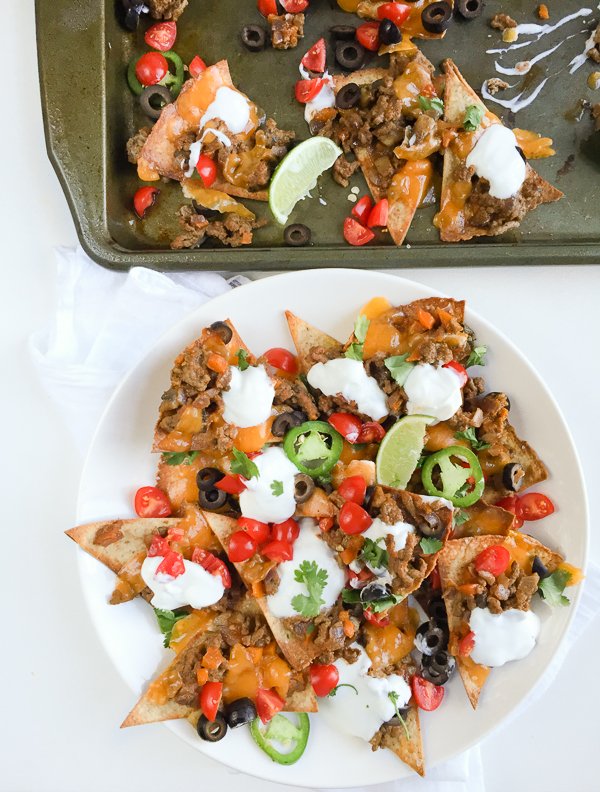 A homemade healthy beef nachos recipe with baked tortilla chips and all the fixins! Here's a hearty portion of your favorite appetizer for only 374 calories!