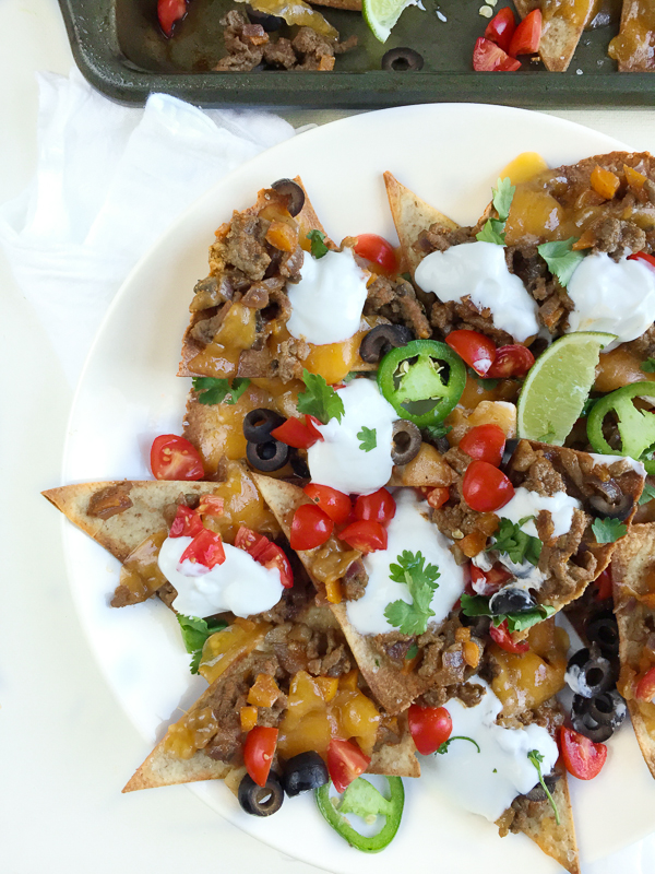 A homemade healthy beef nachos recipe with baked tortilla chips and all the fixins! Here's a hearty portion of your favorite appetizer for only 374 calories!