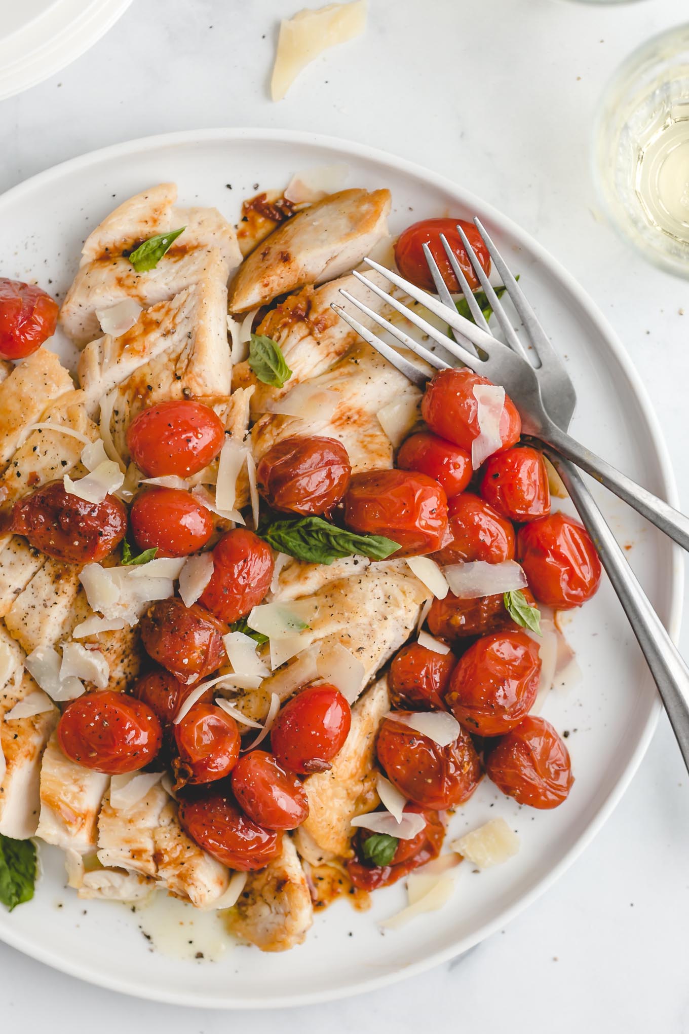 easy chicken recipe of pan-seared chicken breasts topped with sautéed grape tomatoes, garlic, and balsamic vinegar