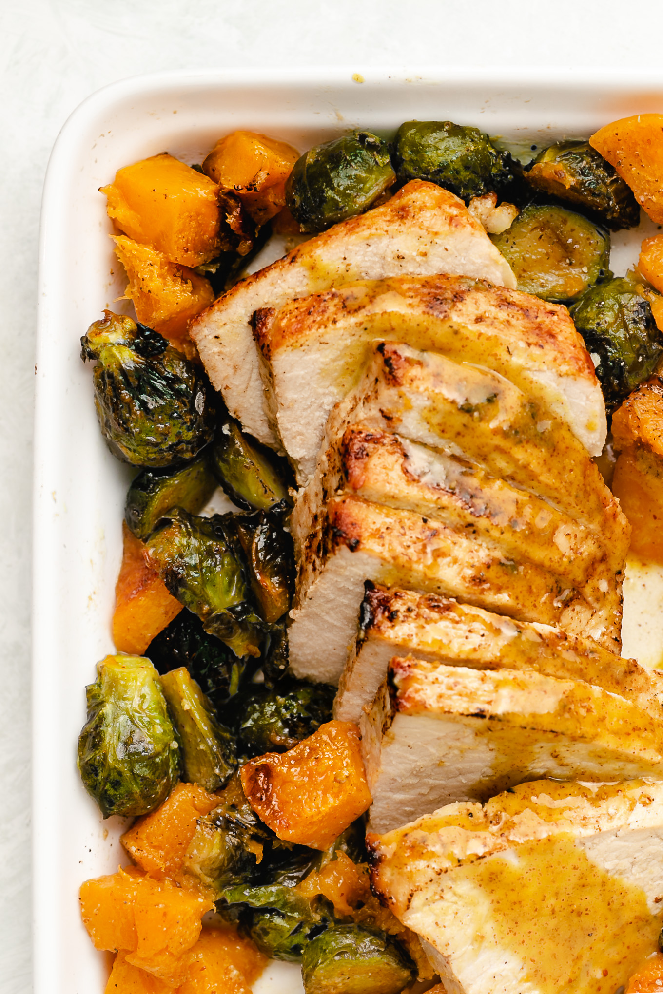 Sheet Pan Pork Tenderloin with Brussels Sprouts and Butternut Squash-
This sheet pan pork tenderloin bakes to perfection in 35 short minutes, topped with a simple but delicious maple-mustard sauce. Surrounding it are tender, caramelized brussels sprouts and sweet butternut squash.