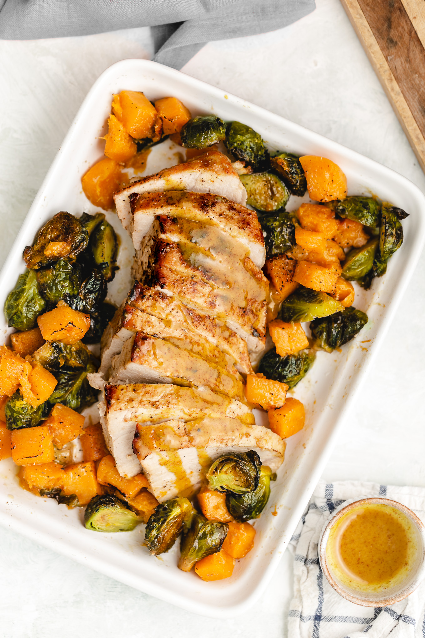 Sheet Pan Pork Tenderloin with Brussels Sprouts and Butternut Squash

This sheet pan pork tenderloin bakes to perfection in 35 short minutes, topped with a simple but delicious maple-mustard sauce. Surrounding it are tender, caramelized brussels sprouts and sweet butternut squash.