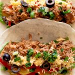 Slow Cooker Mexican Pulled Pork Tacos Recipe - this crock pot pulled pork recipe has outrageous flavor and is easily one of my most requested recipes! Always a hit!