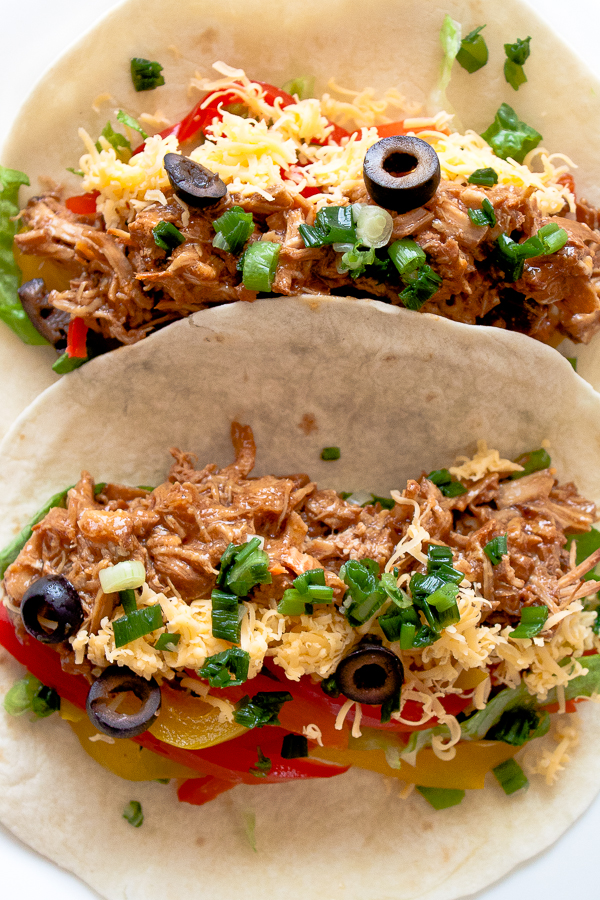 Slow Cooker Mexican Pulled Pork Tacos Recipe - this crock pot pulled pork recipe has outrageous flavor and is easily one of my most requested recipes! Always a hit!