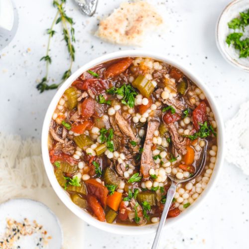 Slow Cooker Beef Soup with Couscous - This delicious slow cooker recipe has all the rich, savory flavor of a long-simmered beef stew, only it's lighter and more brothy, with fall-apart-tender chunks of beef and an aromatic beef broth made with garlic, onion, carrot, celery, bay leaves, fresh thyme, and a bit of soy sauce, which works to enhance that umami beef flavor.
