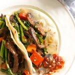 Spicy Beef Tacos Recipe with Broccoli Rabe - marinate your steak in a quick toasted sesame-soy dressing for a flavorful asian fusion taco recipe - paired with superfood broccoli rabe and stuffed in a corn tortilla! An easy weeknight dinner.