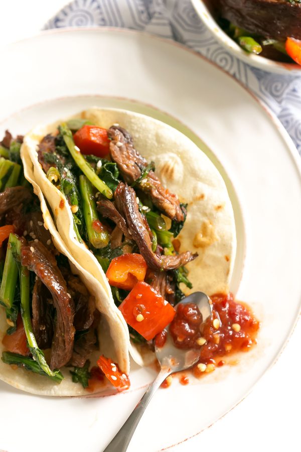 Spicy Beef Tacos Recipe with Broccoli Rabe - marinate your steak in a quick toasted sesame-soy dressing for a flavorful asian fusion taco recipe - paired with superfood broccoli rabe and stuffed in a corn tortilla! An easy weeknight dinner. 