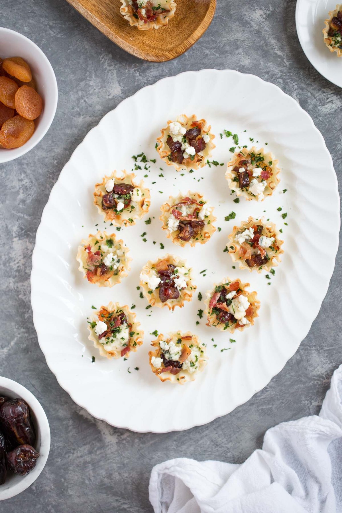 Sweet and Savory Medjool Date, Bacon, and Brie Tarts - Flaky mini fillo dough tarts make an easy, delicious appetizer - and these are perfectly sweet and savory, with brie, blue cheese, bacon, and medjool dates. 