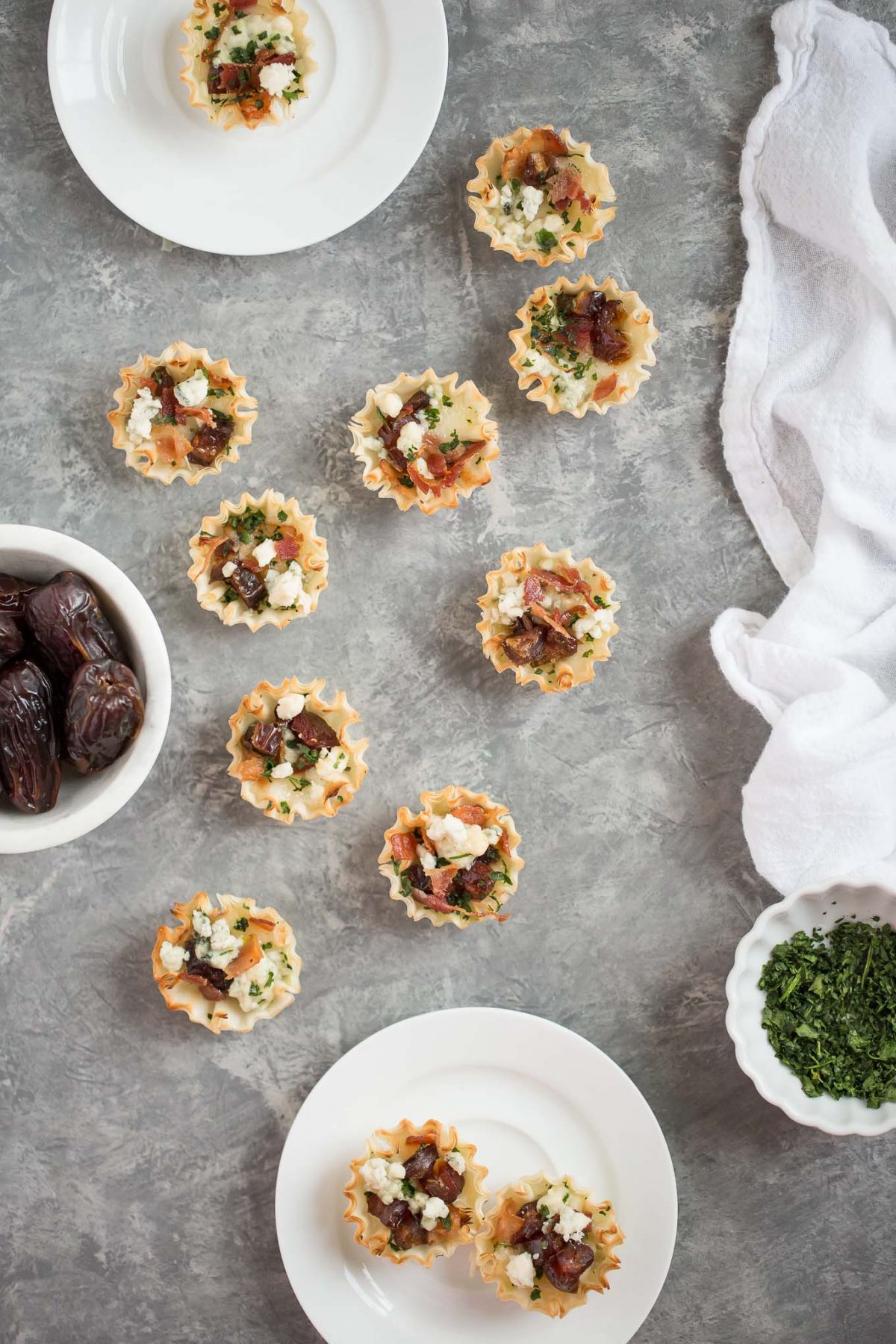 Sweet and Savory Medjool Date, Bacon, and Brie Tarts - Flaky mini fillo dough tarts make an easy, delicious appetizer - and these are perfectly sweet and savory, with brie, blue cheese, bacon, and medjool dates. 