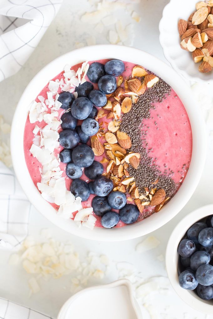Triple Berry Beet Smoothie Recipe - a healthy smoothie made with raspberries, strawberries, blueberries, beet, banana, coconut milk, almonds, and chia seeds! 230 calories for the smoothie alone, 340 calories with toppings! 