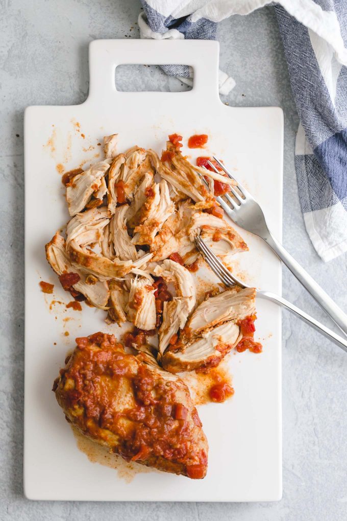 The Best Lighter Chicken Nachos! 396 calories or 8 WW points. Piled high with crisp tortilla chips, delicious and easy slow cooker Mexican shredded chicken, seasoned black beans, melted cheddar cheese, and all the fixins!