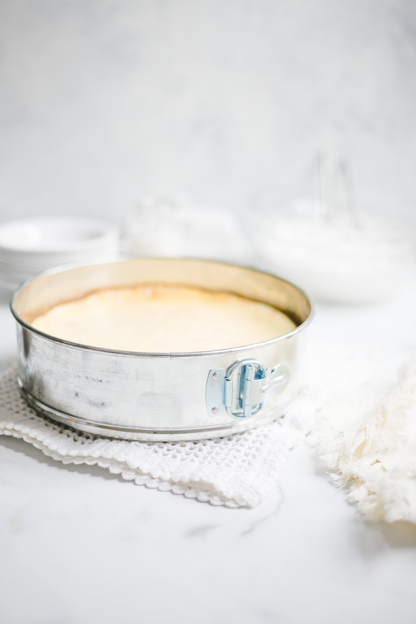 White Chocolate Peppermint Cheesecake - Smooth and creamy white chocolate cheesecake infused with cool peppermint flavor, a substantial chocolate cookie crust, and a cloud cover of whipped cream make this cheesecake recipe the holiday season’s best, most beautiful dessert! 