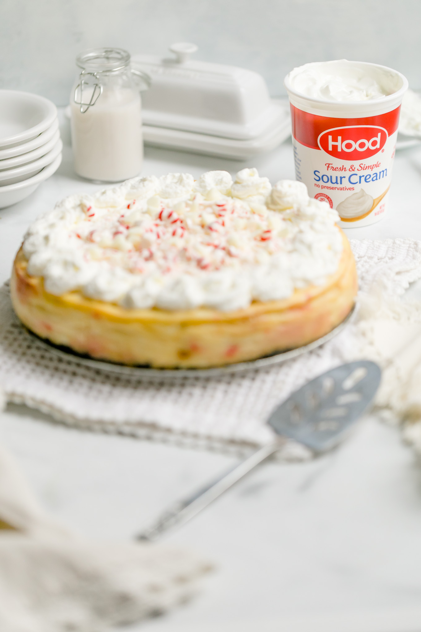 White Chocolate Peppermint Cheesecake - Smooth and creamy white chocolate cheesecake infused with cool peppermint flavor, a substantial chocolate cookie crust, and a cloud cover of whipped cream make this cheesecake recipe the holiday season’s best, most beautiful dessert! 
