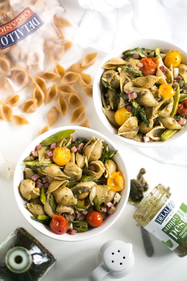 Whole Wheat Pasta Salad with Pesto, Asparagus and Roasted Tomatoes - A flavor-packed pasta salad can be easy and healthy, too, and this recipe is proof. Slather DeLallo whole wheat shells in basil pesto, then toss them with roasted asparagus, sweet blistered tomatoes, charred artichokes, and salty bits of prosciutto. All this for only 249 calories per serving